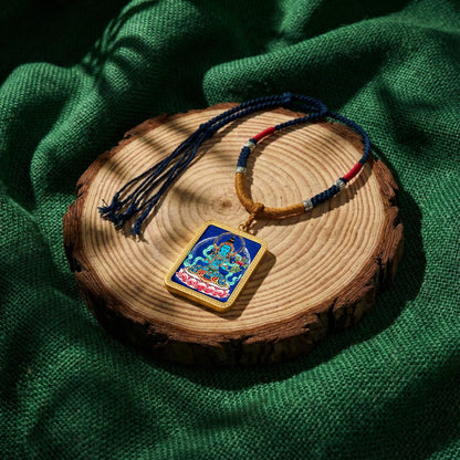 Tibetan Buddhist thangka pendant necklace on wooden slab with woven cord, spiritual jewelry